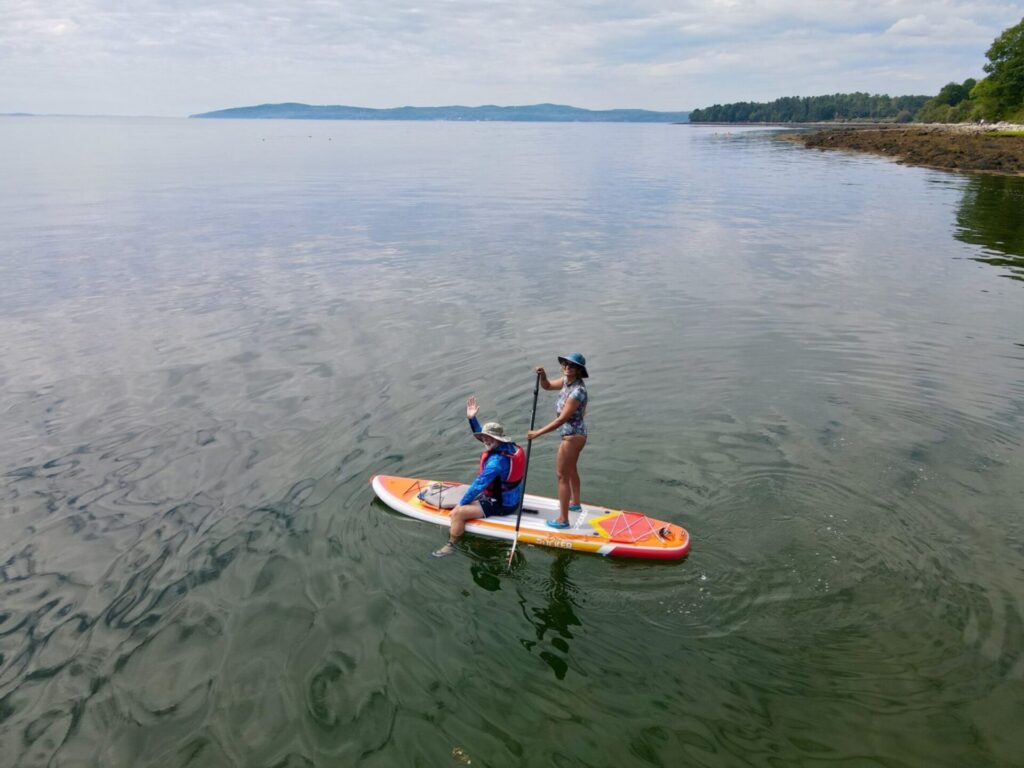 Couple paddle boarding on Penobscot Bay