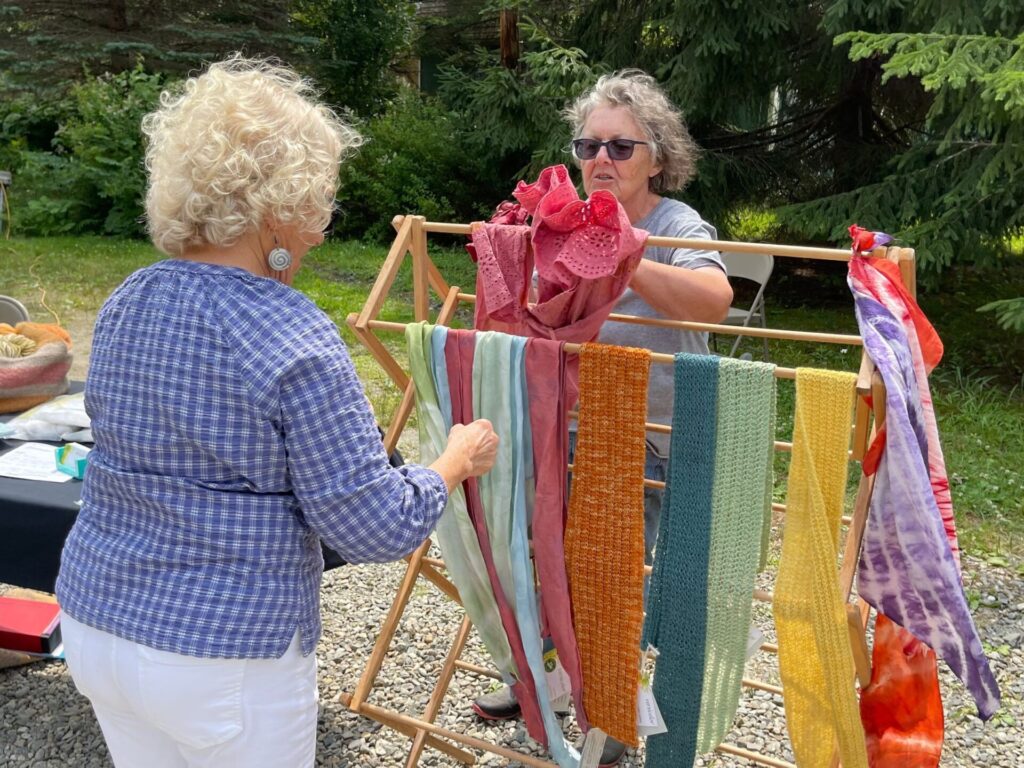 two women with naturally dyed textiles